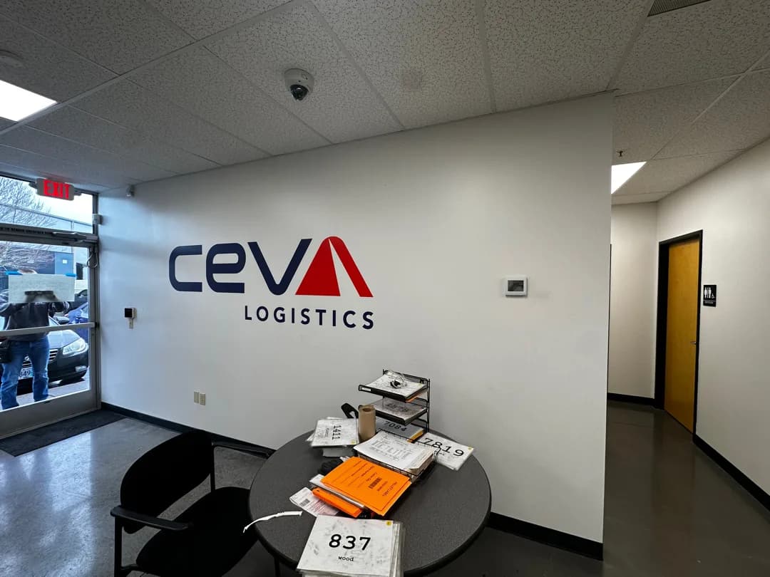 CEVA logo wall graphic installed in an active office