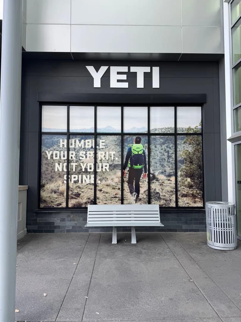 Yeti storefront between seasonal window graphic installations
