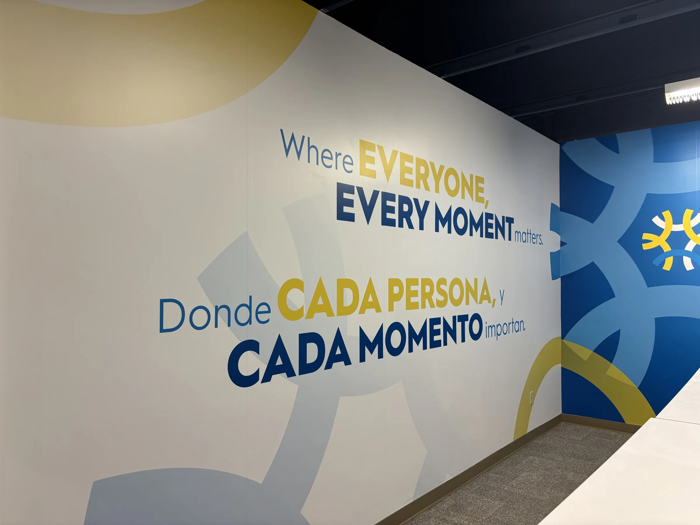 Completed bilingual Unitus Banking Center wall graphic at BizTown PDX