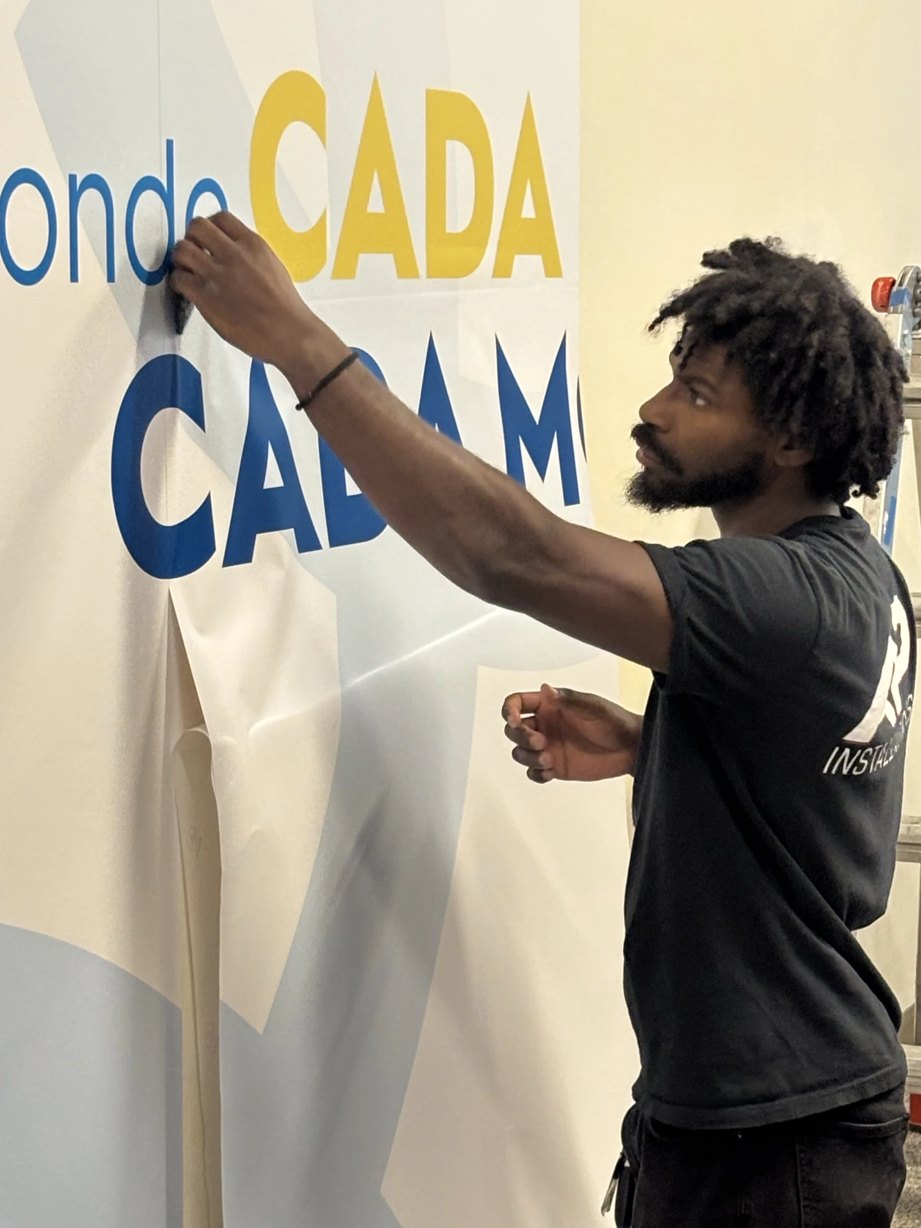 AP installer applying Unitus Banking Center wall graphics