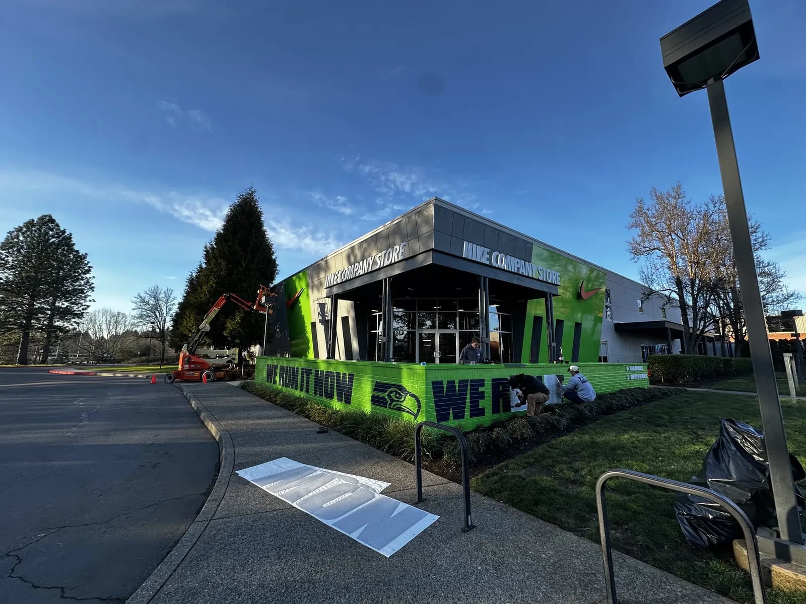AP crew and boom lift installing the Seahawks building wrap graphics