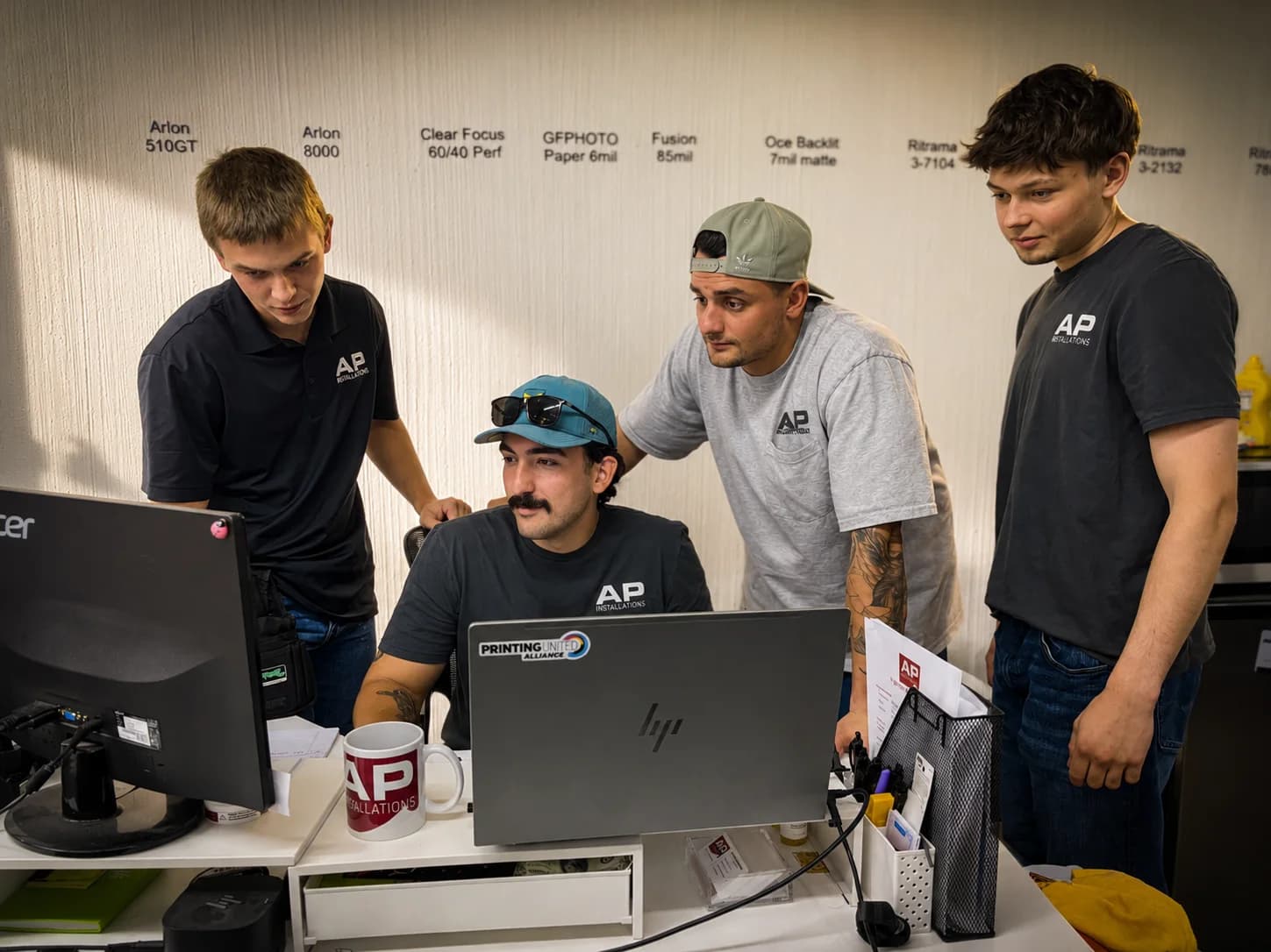 AP Installations team reviewing a graphic installation project