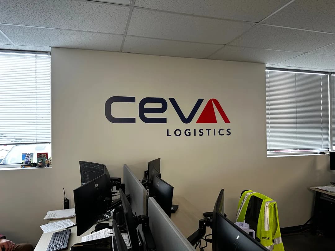 CEVA Logistics wall graphic installed above workstations in a corporate office