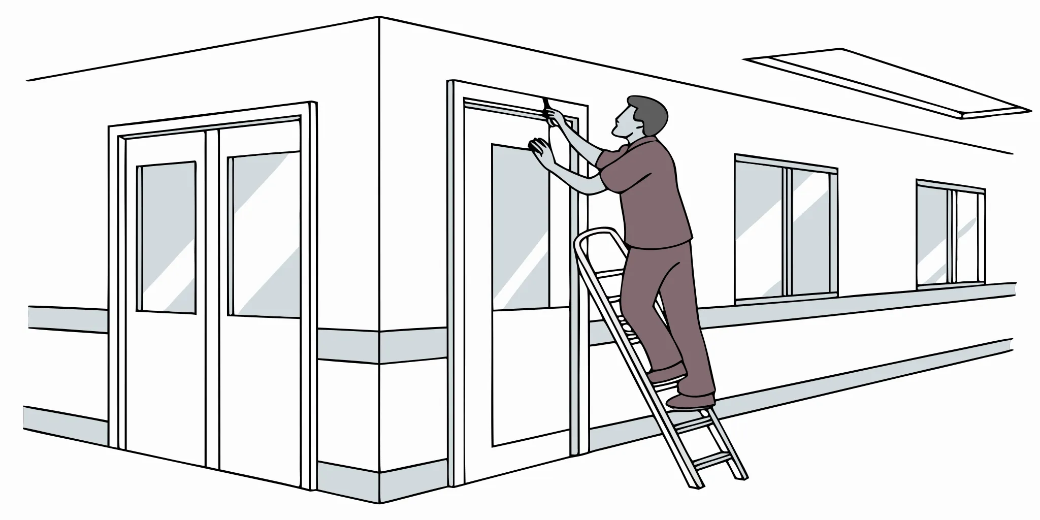 Vinyl graphics installer applying wayfinding graphics in a healthcare clinic