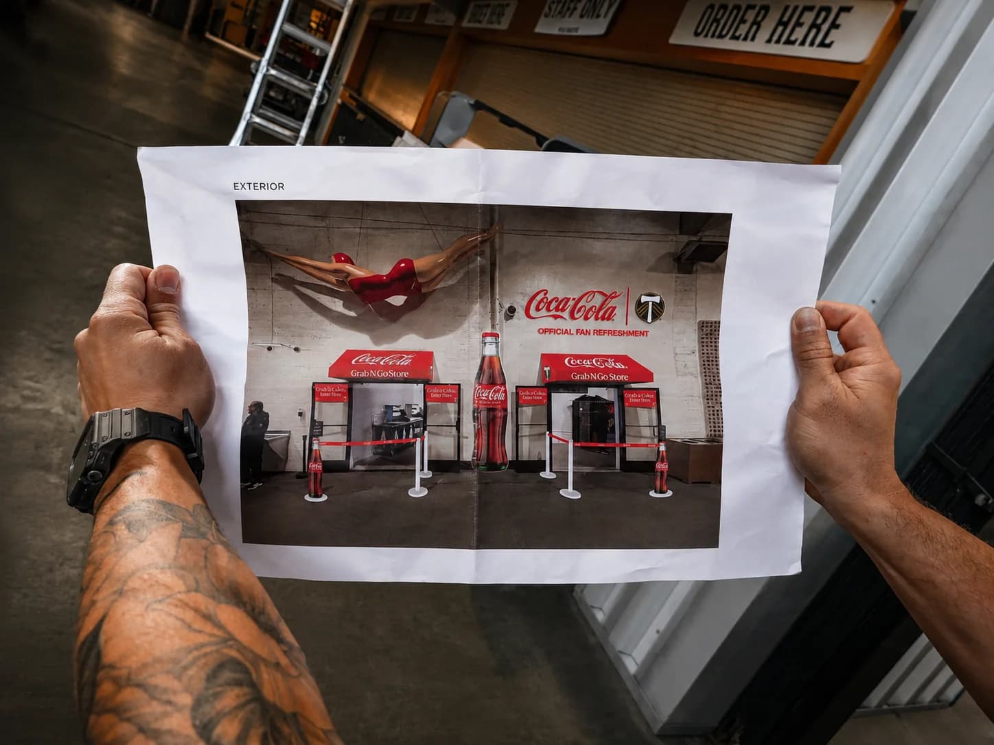 Installer comparing a printed plan with a branded environment