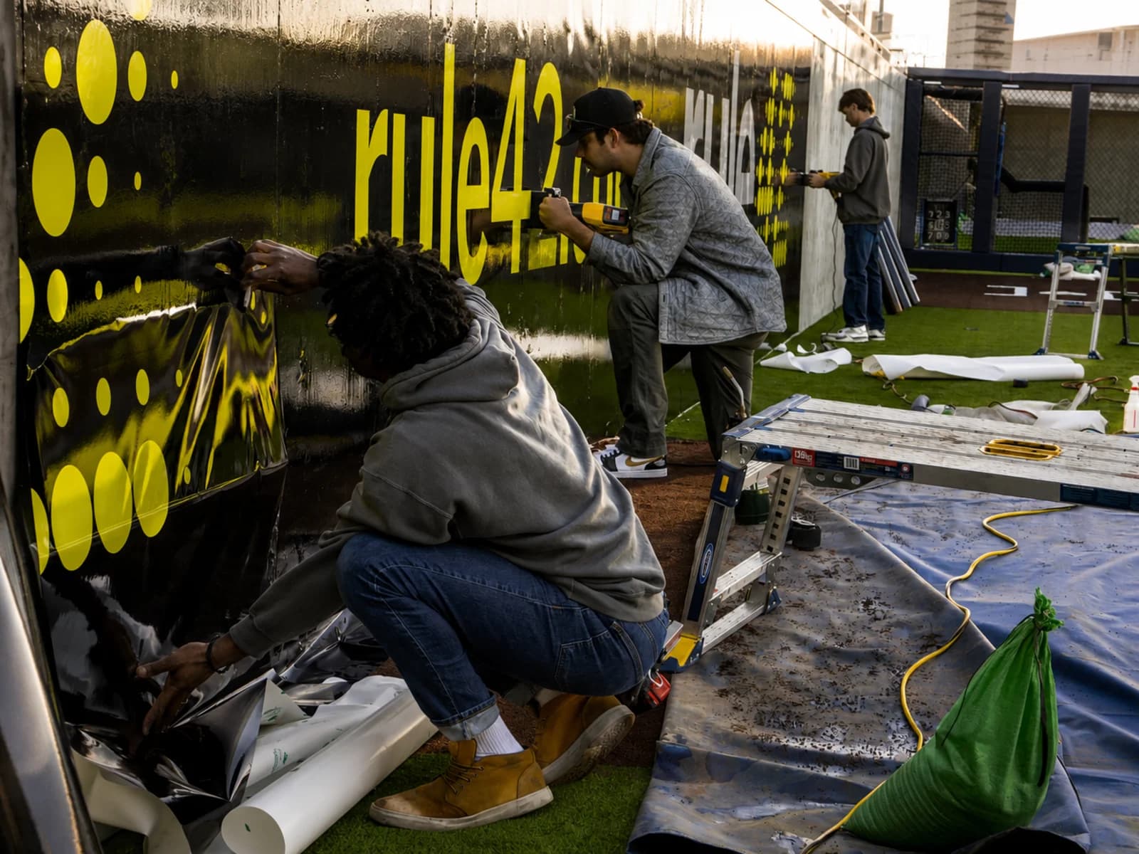 AP Installations crew applying large-format graphics at the rule42 batting cage