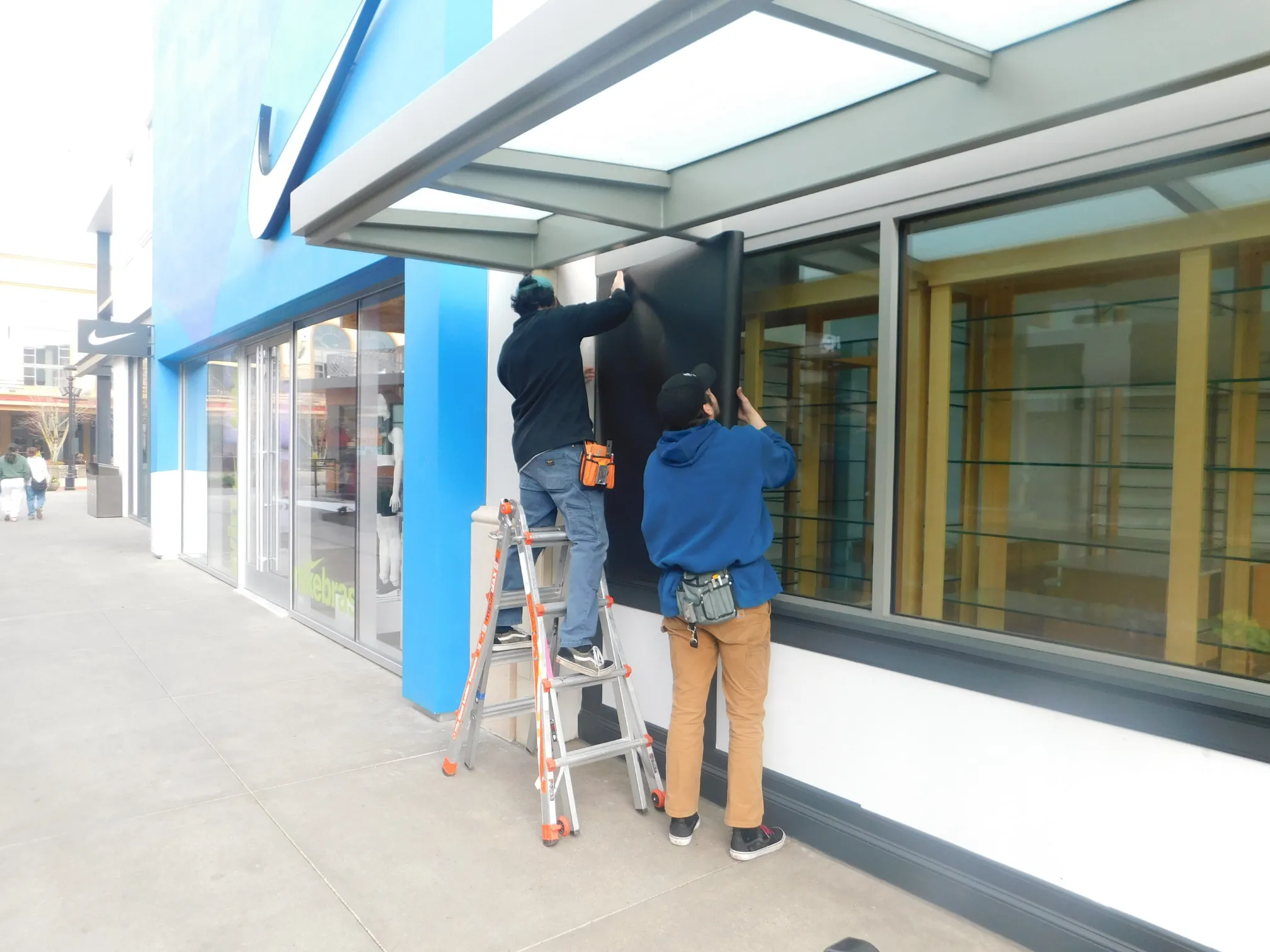 Installer preparing a vinyl graphic surface before professional application
