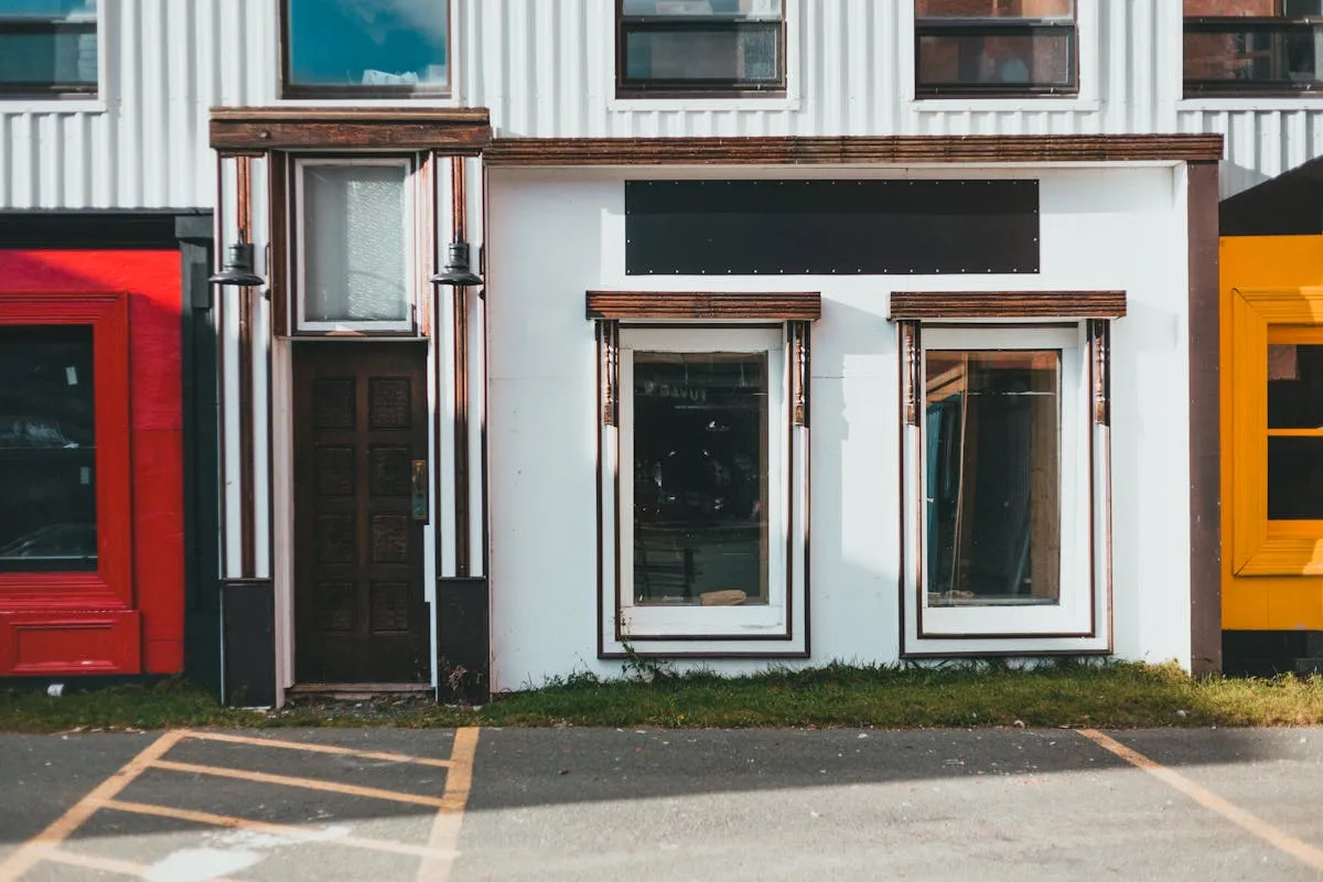 Vibrant storefronts with large glass windows showcasing colorful window graphics and business branding