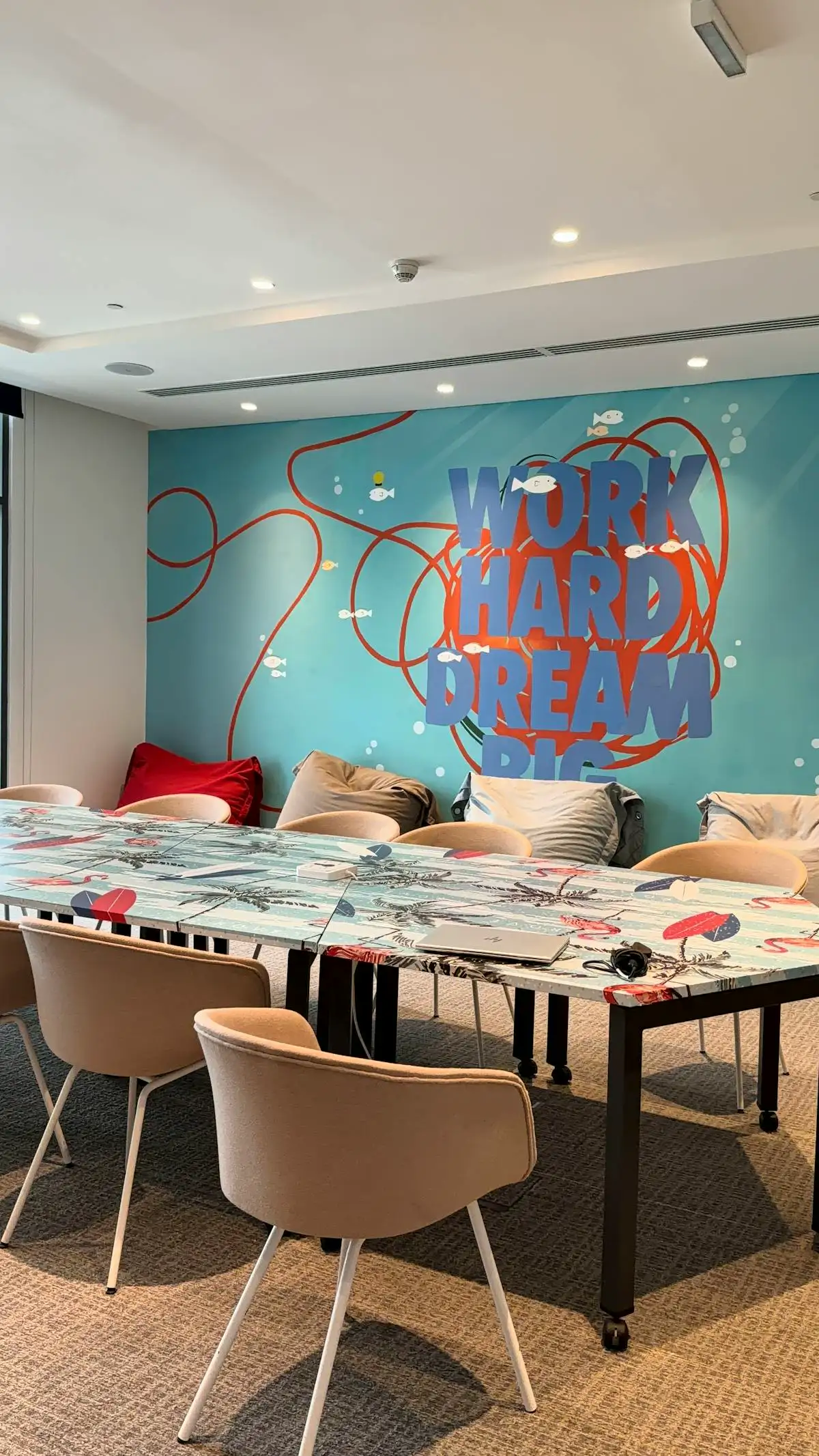 Motivational wall art in a modern meeting room showcasing experiential graphics