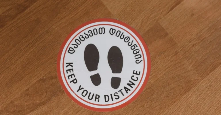 Removable floor decal with safety messaging applied to a commercial wood floor