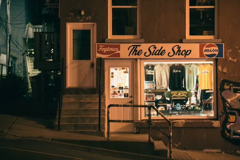 Illuminated retail storefront with professional window graphics and signage