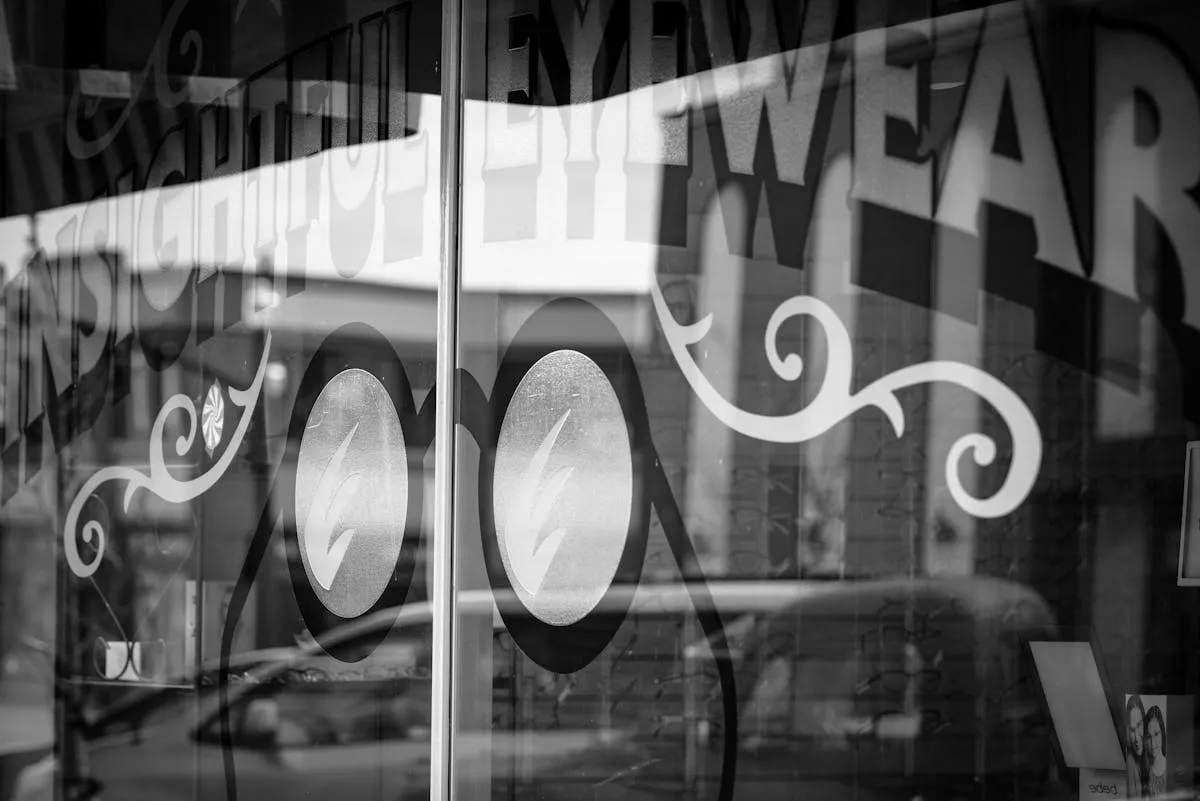 Reflective storefront window with professional graphic design applied to business glass surfaces